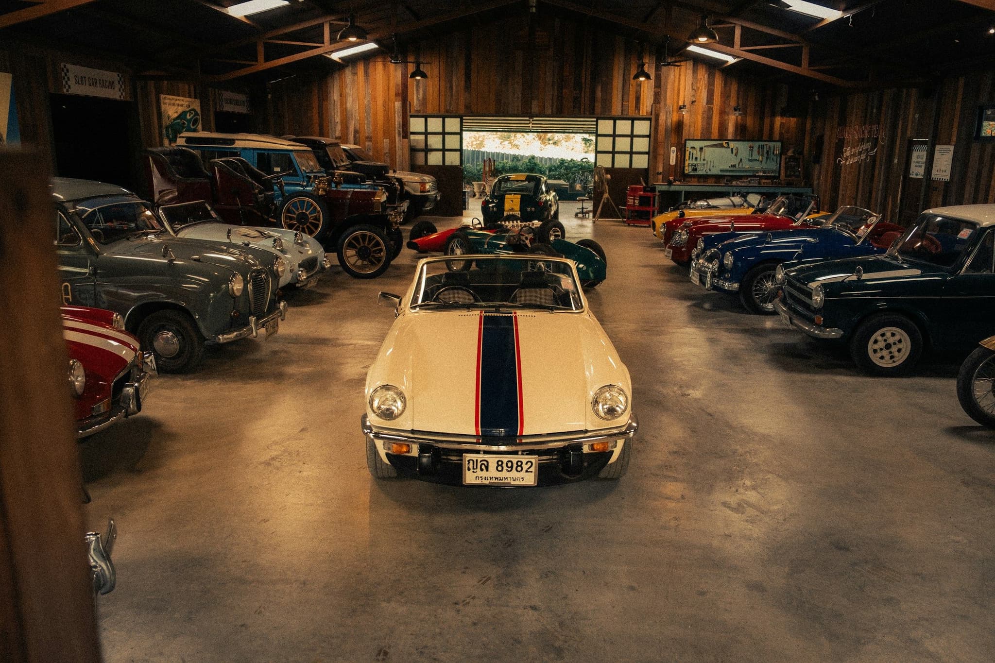 A private collection of vintage cars in a timber-framed garage